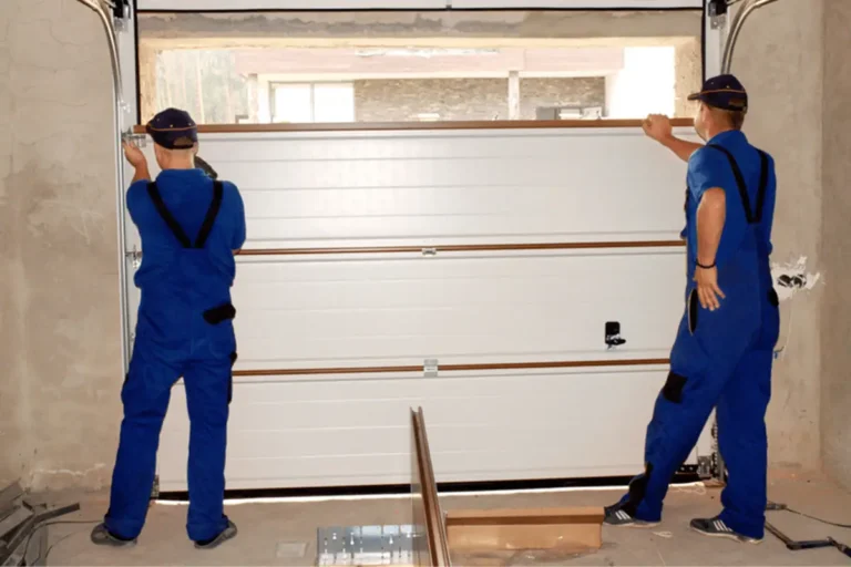 two men repearing a garage door 768x512